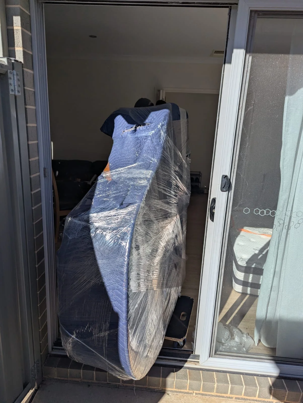A large item protected in wrapping at an entrance