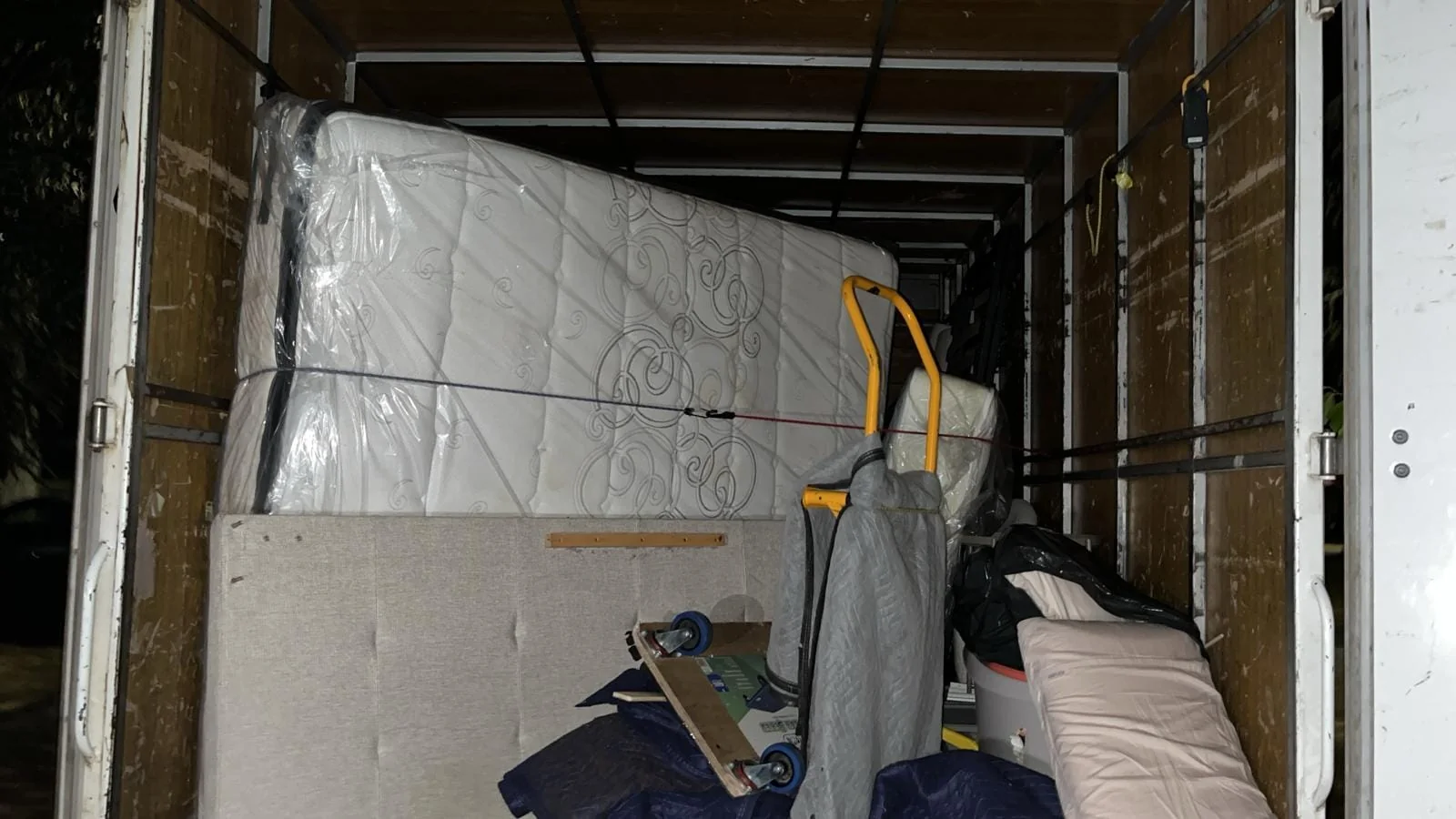 Wrapped furniture secured inside a moving truck