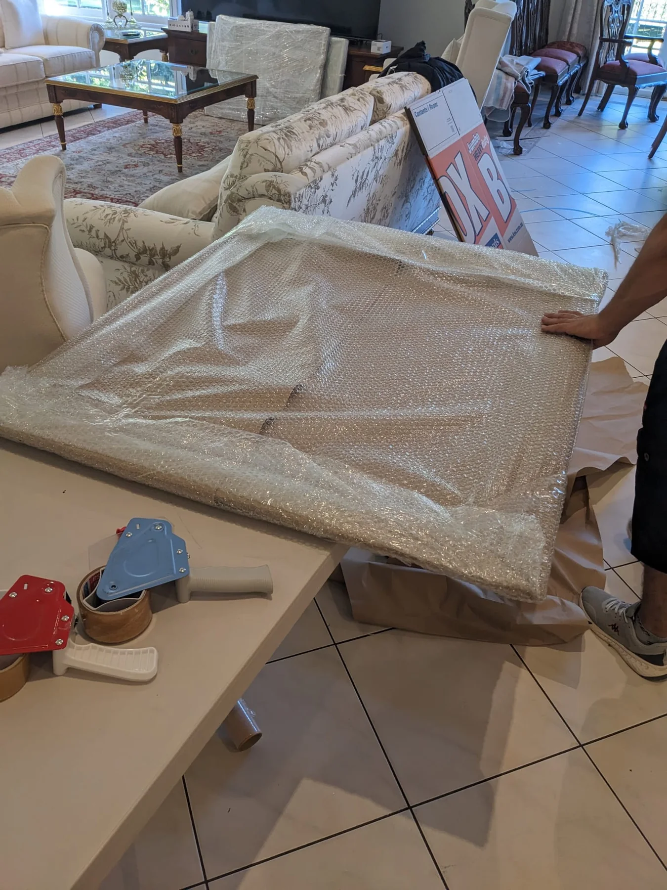 Wrapped household furniture prepared for pickup